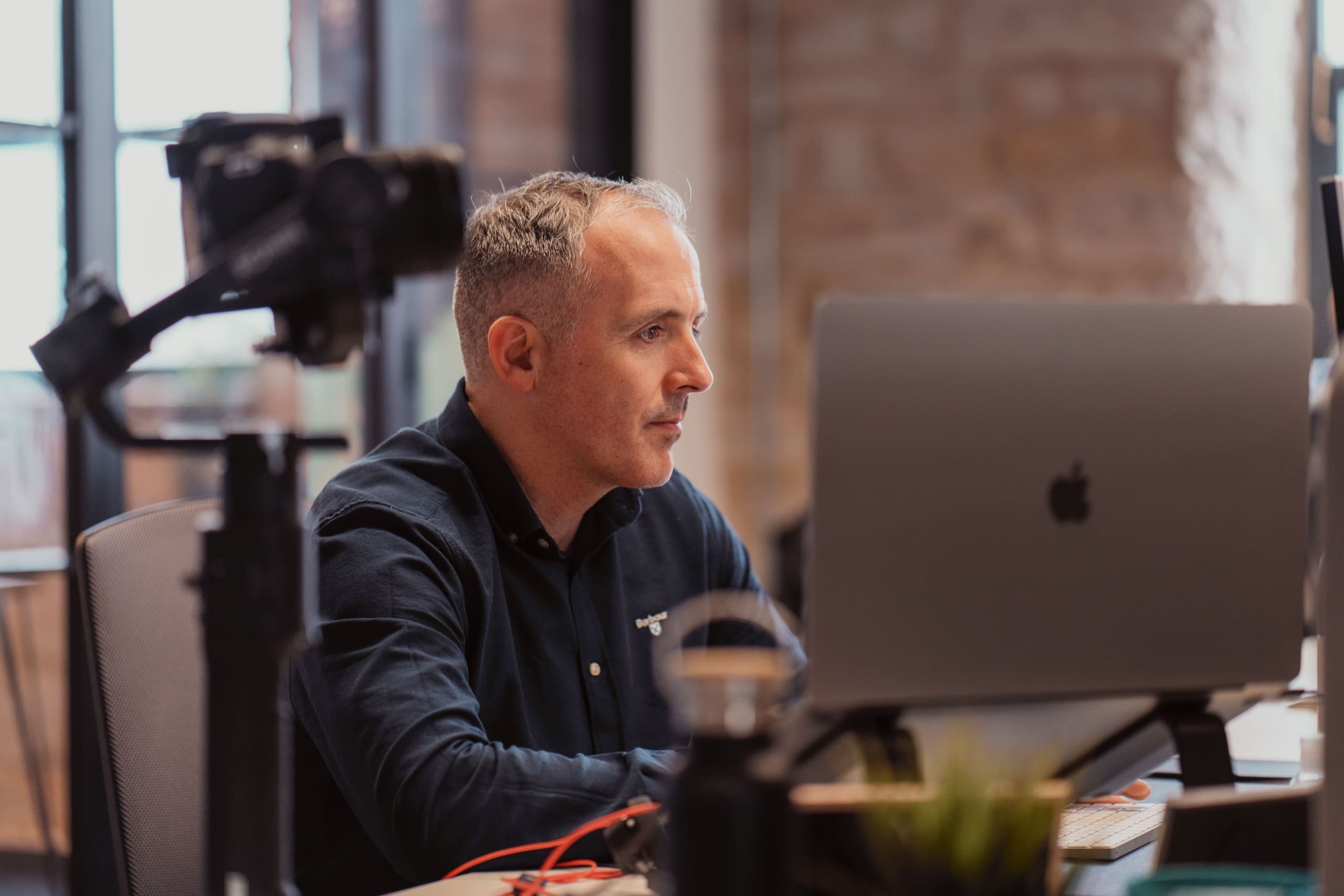 Photo of Managing Director Sean looking at a computer screen