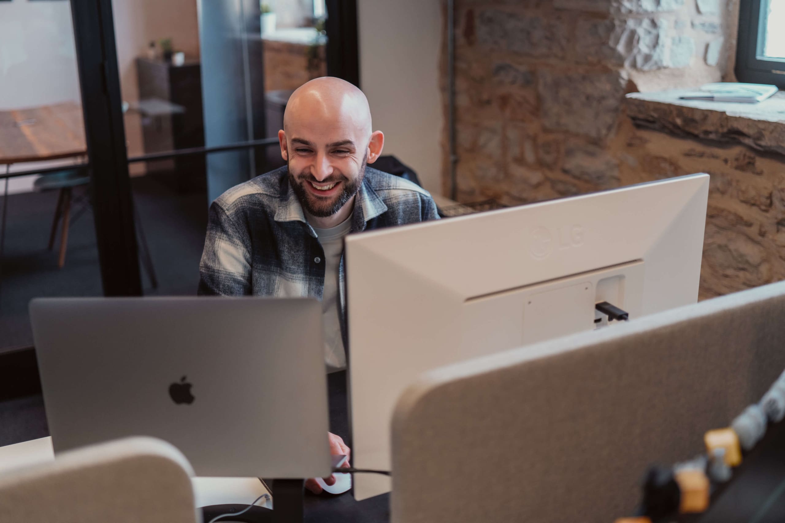 Managing Director Alex Heeney in front of a computer screen